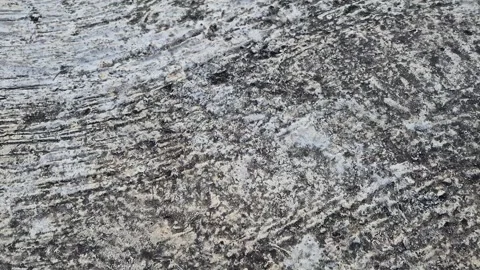 A close-up shot shows a rough, weathered concrete surface Stock Footage 339657874
