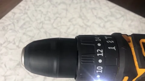 A close-up shot of the silver metal Phillips head screw bit and black chuck.. Vídeo Stock 323215197