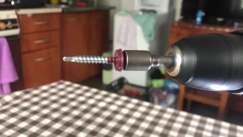 A close-up shot of the silver metal Phillips head screw bit and black chuck.. Vídeo Stock 323216141