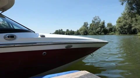 Close-up shot of a ski boat docked at the pier on a lake. Stock Footage 201366011