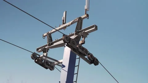 Close-up shot of ski lift support tower with a T-bar on a sunny winter day 스톡 동영상 150982465