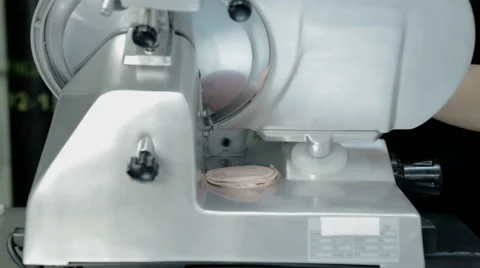 Close up shot slice machine cuts ham and meat Stock Footage 65805825