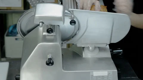 Close up shot slice machine cuts ham and meat Stock Footage 65806153