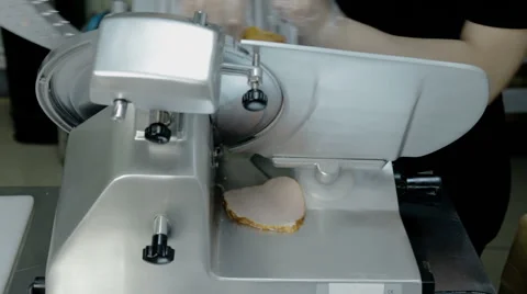 Close up shot slice machine cuts ham and meat Stock Footage 65806170