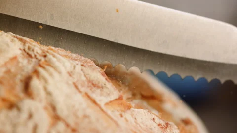 Close up shot slicing fresh bread in slow motion Stock Footage 153466054