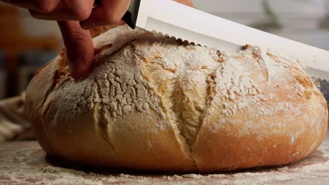 Close up shot slicing fresh bread in slow motion Stock Footage 153466142