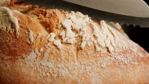 Close up shot slicing fresh bread in slow motion Stock Footage 153466313