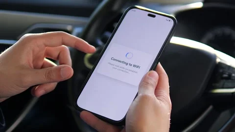 Close-up shot in slow motion of hands establishing a Wi-Fi connection through a Stock-Footage 316807441