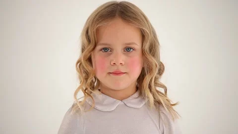 Close up shot of small cute nice little girl child toddler with rosy cheeks blon Stockbeeldmateriaal 132674753