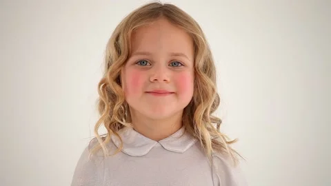 Close up shot of small nice cute little girl child toddler with rosy cheeks blon Stockbeeldmateriaal 132674756