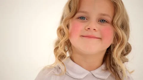 Close up shot of small nice cute little girl toddler child with curly blond hair 動画素材 132674844