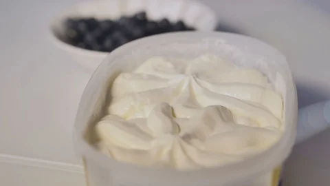 Close-up shot of small portion taken from bowl with white ice cream using spoon. Stock Footage 116055363