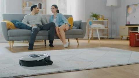 Close Up Shot of a Smart Robot Vacuum Cleaner Sucking Up Dust from a Carpet. Stock Footage 102312609