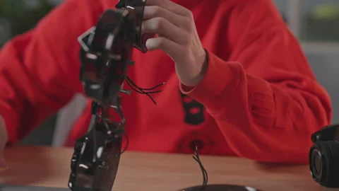 Close-up shot of smart young man holding in hands black elements of quadcopter Stock Footage 195275913