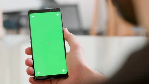 Close-up shot of a smartphone with green screen on in man's hand Stock Footage 105701019