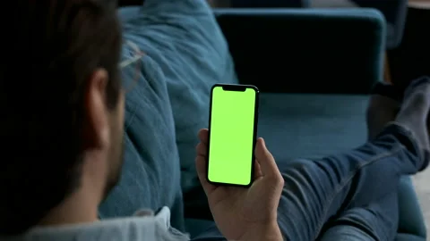 Close-up shot of a smartphone with green screen on in man's hand Video stock 144683331