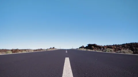 Close-up shot of a smooth motion over the asphalt surface of the road with a Vídeos de archivo 98456126