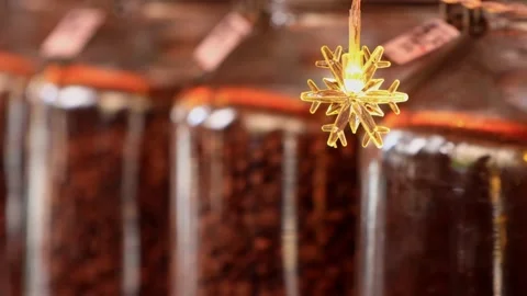 Close up shot of a snow shape bulb with coffee bean as background Video stock 230394316