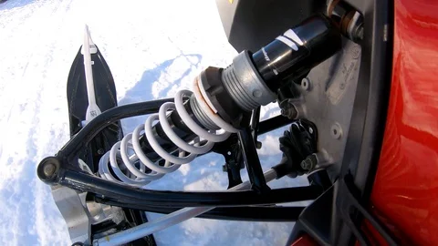 Close up shot of snowmobile ski as it moves on the snowy road Stockbeeldmateriaal 108940917