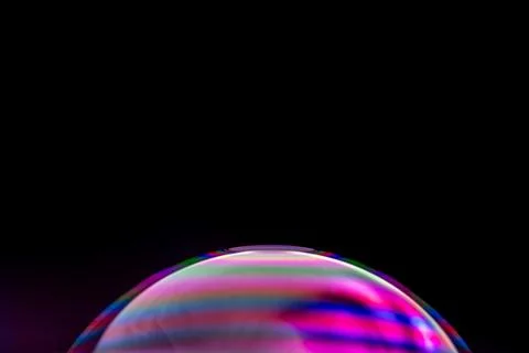 Close-up shot of soap bubble with light interference patterns isolated on a blac Stock Photos