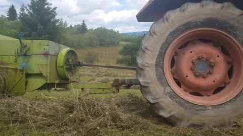 Close Up shot of a Square Hay Baler and Tractor in Transilvania Romania Video stock 112191076