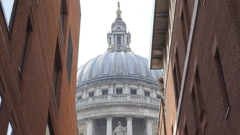 Close up shot of St Paul Cathedrals dome in between two buildings. London. Stock Footage 100824296