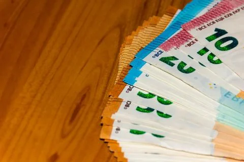 A close-up shot of a stack of euro banknotes on the table Stock Photos