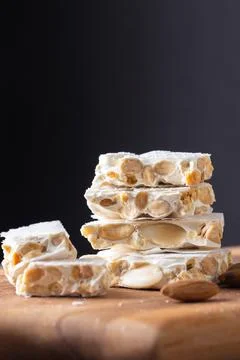A close-up shot of a stack of four pieces of hard white turron, a traditional Stock Photos