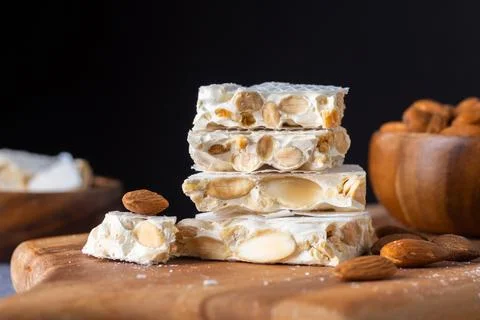 A close-up shot of a stack of four pieces of hard white turron, a traditional Foto stock