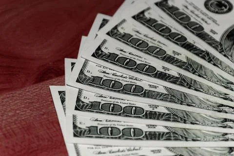 A close-up shot of a stack of several 100 (hundred) US dollars banknotes on t Stock Photos