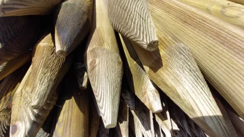 Close-up shot of a stack of sharpened wooden fence posts and stakes drying in th Vídeos de archivo 336484615