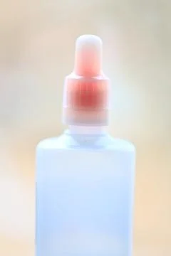 A close-up shot of a standard-sized toothpaste bottle with cap off, showing the Stock Photos