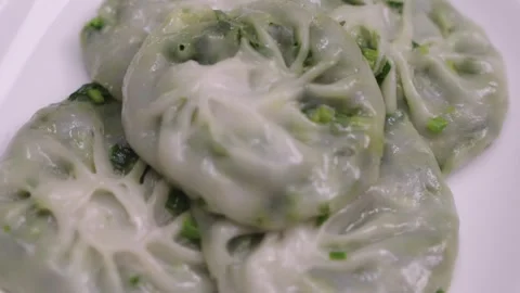 Close-up shot of steamed Chinese chive dumplings with translucent dough and.. Stock Footage 336098656