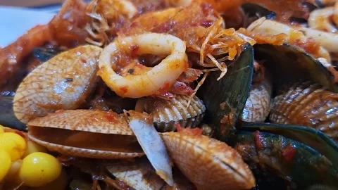 Close-up shot of a steaming, delicious seafood dish covered in rich red chi.. Stock Footage 339119048