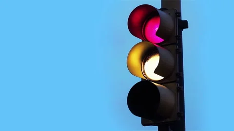 Close-Up Shot of Street Traffic Light Changing from Red to Green at Dusk - 4K Stock Footage 343473152