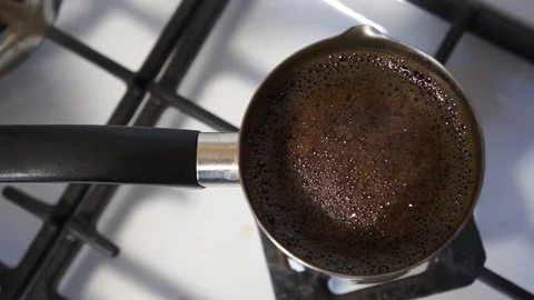 Close up shot of a strong black coffee in Cezve. Preparation of Turkish coffee. 動画素材 76271428