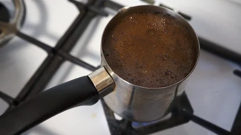 Close up shot of a strong black coffee in Cezve. Preparation of Turkish coffee. Stock Footage 76273585