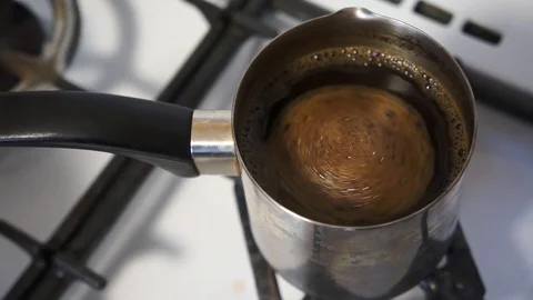 Close up shot of a strong black coffee in Cezve. Preparation of Turkish coffee. Stock Footage 76274596