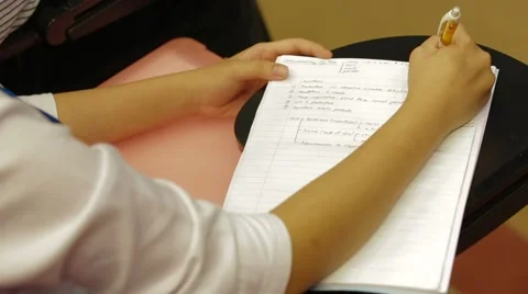 Close Up Shot of A Student Writing Class Notes Inside His Book Stock Footage 49388508