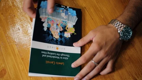 Close shot of student's hand opening book and leafing papers in library Stock Footage 118214235