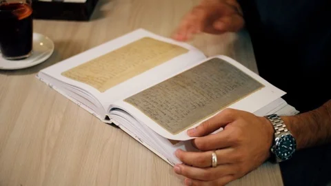 Close shot of student's hands reading modern book in coffee shop Stock Footage 118214362