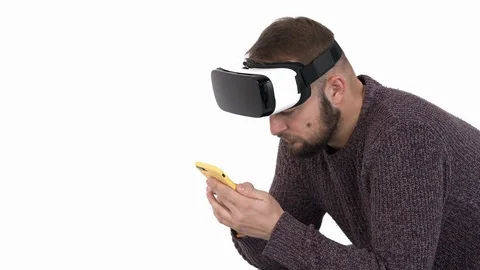 Close-up shot of stylish cool guy in trendy VR glasses using his smartphone. Stock Footage 121196485
