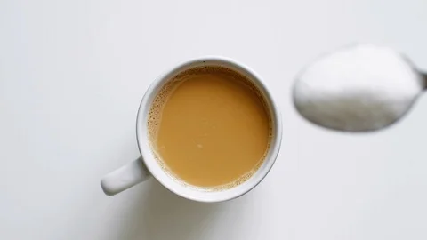 Close up shot of sugar being poured into coffee Stock Footage 104557032