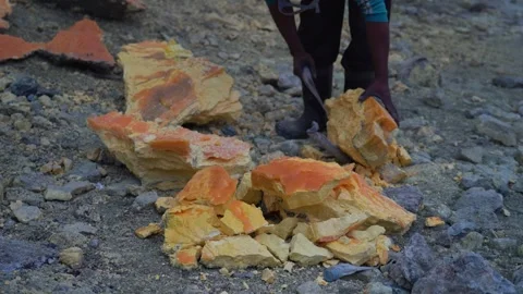 Close-up shot of sulfur being extracted from Kawah Ijen volcano, Java, Indonesia Stock Footage 263981444