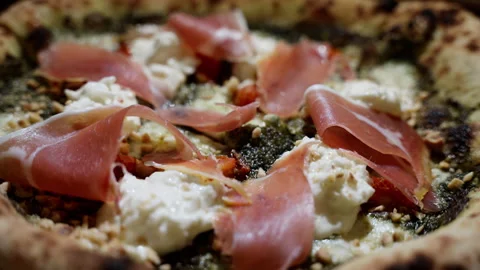 Close-up shot of a sumptuous Parma ham pizza, bathed in alluring moody lighting Stock-Footage 249713561