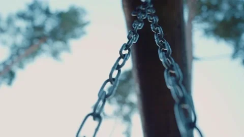 Close-up shot of the swinging chain on the swing. Bottom up view. Stock Footage 139785660
