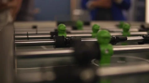 A close up shot of table soccer which is being played by group of young Stock Footage 202899214