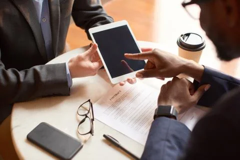 Close up shot of a tablet held by a man. Stock Photos