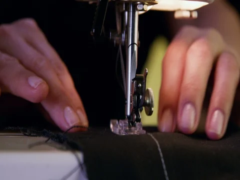 Close up Shot of a Tailor behind a Sewing Machine Stock Footage 84004817