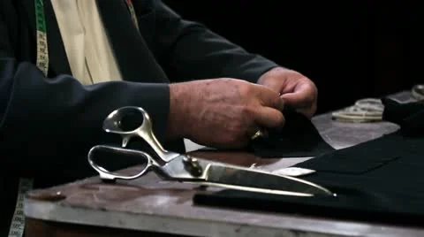 Close up shot of a tailor sewing  a button Stock Footage 27799721